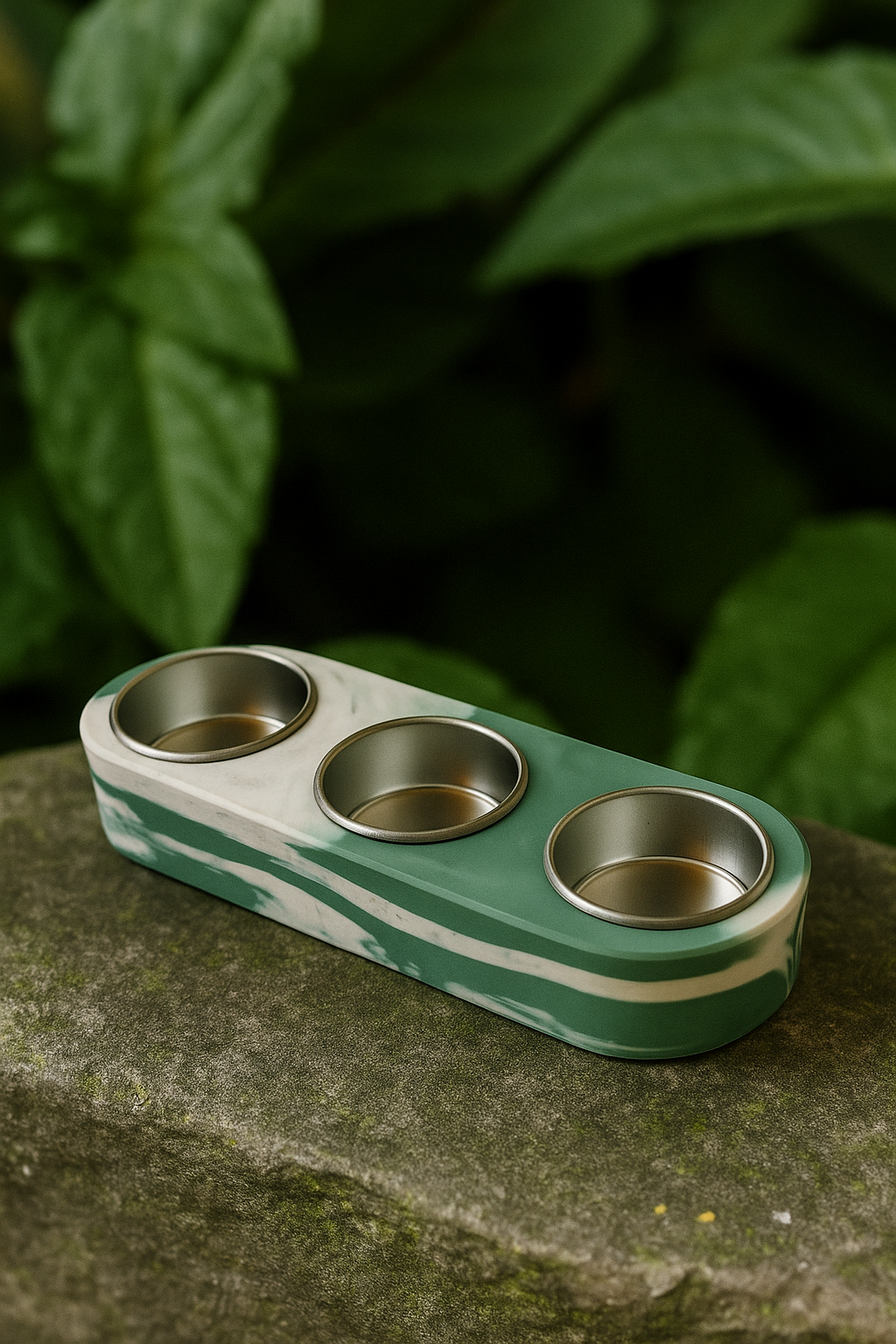 Green and white striped fidget spinner on a stone surface with green leaves in the background